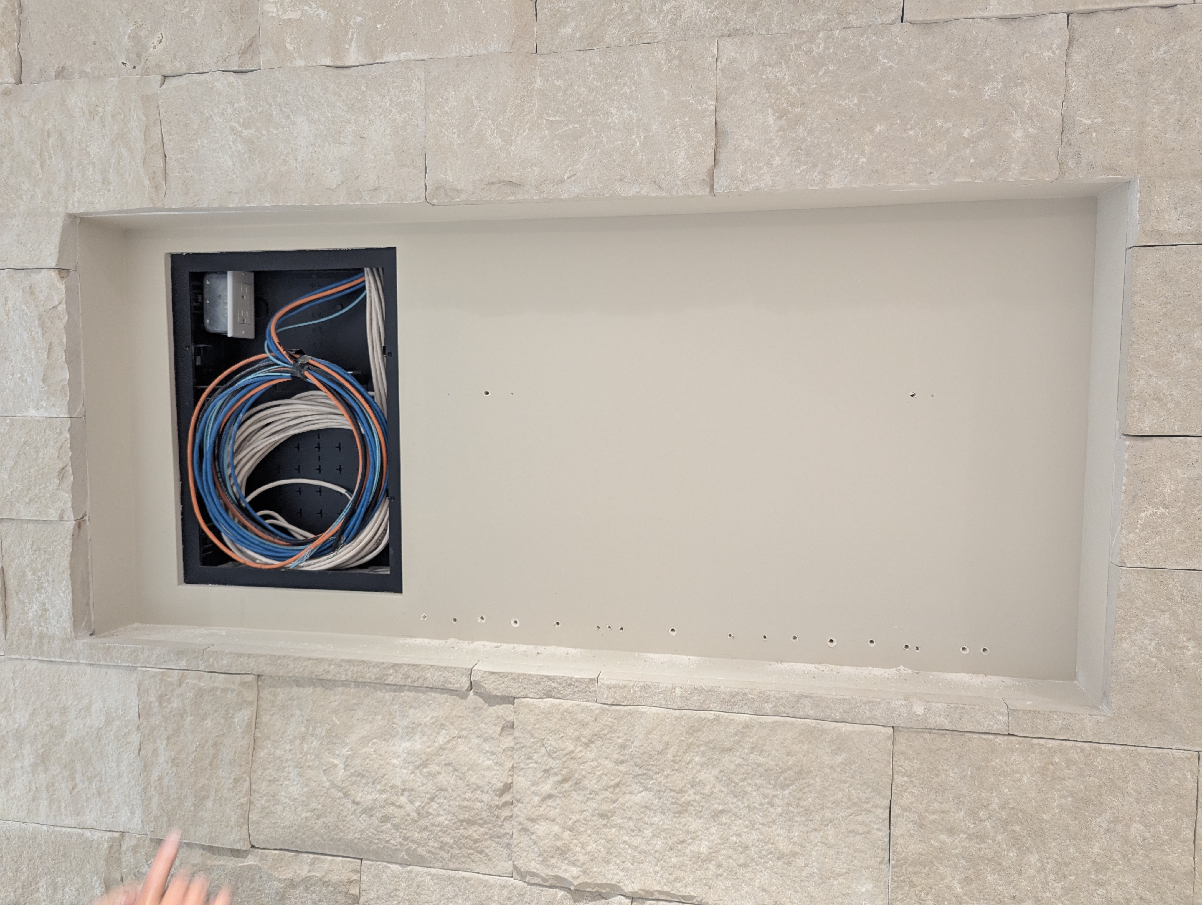 Low voltage wiring niche in stone wall